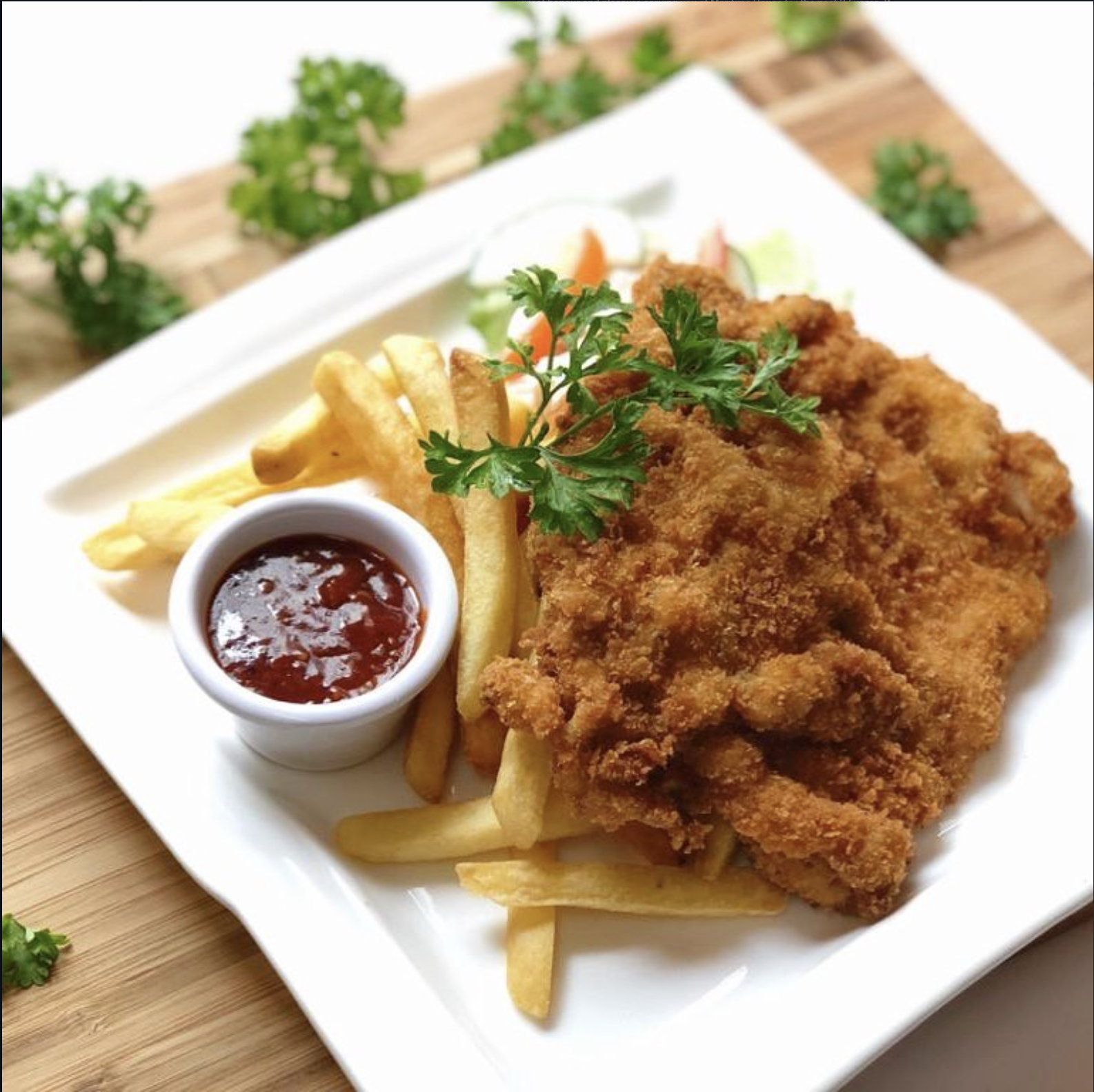 Breaded Hainanese-style chop with fries and sauce